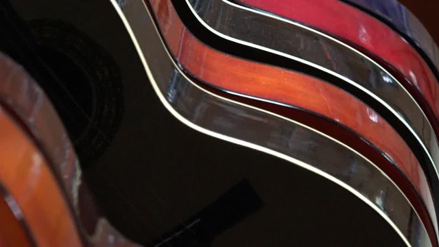 Dusty guitars in store stand in a row, of different colors. Music shop