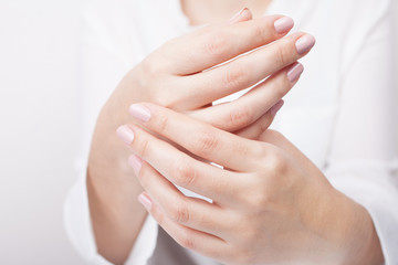 woman hands applying moisturizing cream to her skin