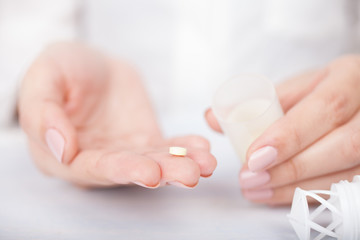 woman's hands with pills