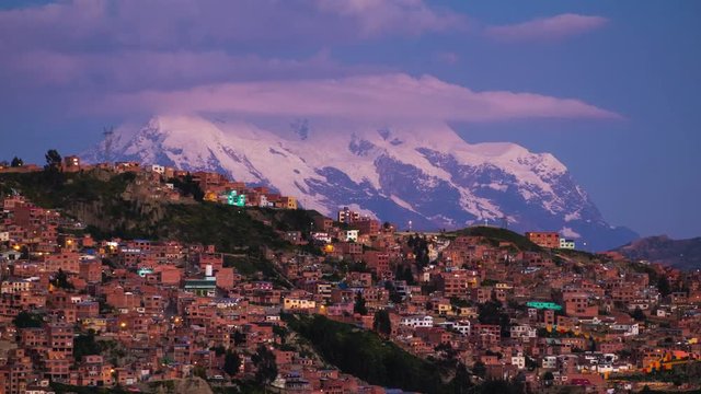 Zoom out timelapse of the mountain of Illimani and the city of La Paz during sunset, Bolivia.