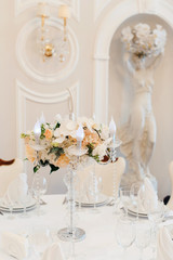 Wedding tables set for banquet or wedding event catering. Party celebration wedding concept. Flowers wedding decoration of tables for guests of bride and groom. Table appointment event