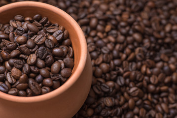 Clay pot filled with coffe beans. Horizontal view