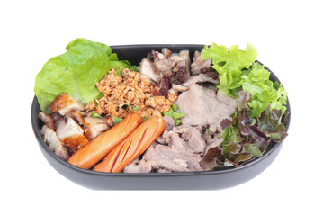 Variety of pork seasoning and serve. Pork in sauce,roast pork with crispy rind, smoked sausage and fresh vegetables served.
