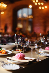 Wedding tables set for banquet or wedding event catering. Party celebration wedding concept. Flowers wedding decoration of tables for guests of bride and groom. Table appointment event