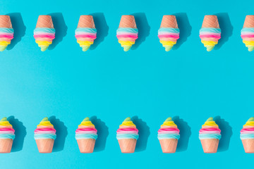 Colorful ice cream pattern on pastel blue background. Creative minimal summer flat lay.