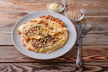 Vegetarian Omelette with fried cabbage, beans and spices on a wooden table. Healthy breakfast concept. Traditional Mediterranean cuisine. Selective focus. Low key