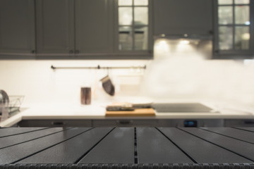 Blurred background. Modern defocused grey kitchen or cafe with tabletop and space for you.