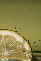 Fototapeta na wymiar Isolated macro of a lemon slice in water background