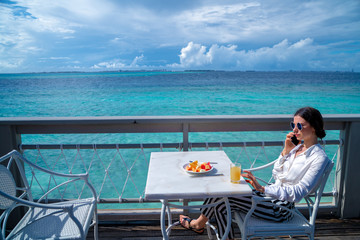 Girl at breakfast talking on the phone