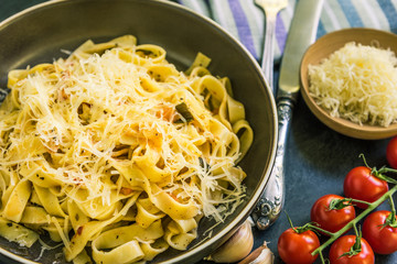 Traditional Italian vegetarian dish - pasta fettuccine with tomatoes in rustic plate