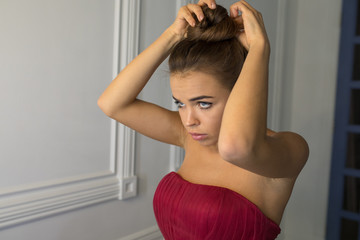 Attractive woman adjusts her hair.