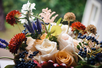 Beautiful close-up of a flower arrangement or bouquet with colorful flowers. Decoration of wedding reception or bridal bouquet. Macro shot flowers with selective focus