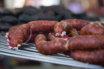 Fototapeta premium Different kinds of fresh spanish sausages on the marketplace. Close up. Soft focus.