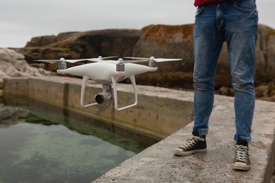 Man operating a flying drone
