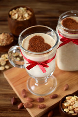 Milkshake decorated with cinnamon heart in glass vessels