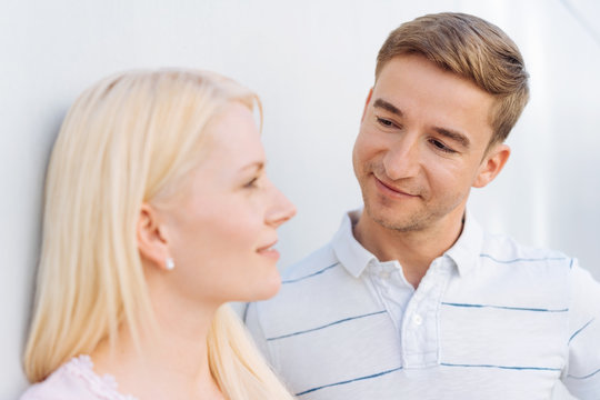 Quizzical young man looking at his girlfriend