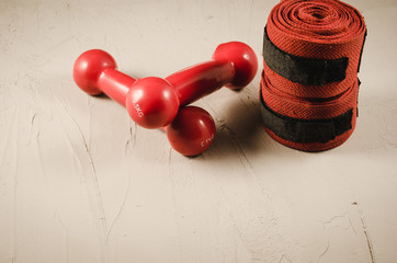 boxing concept with red dumbbells and bandage/boxing concept with red dumbbells and bandage on a stone background