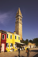 Burano central square. People, tourists walking. Italy