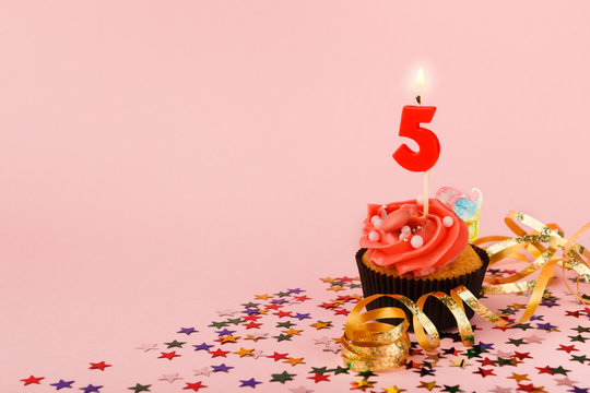 Fifth birthday cupcake with candle and sprinkles