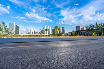 empty asphalt road with city skyline