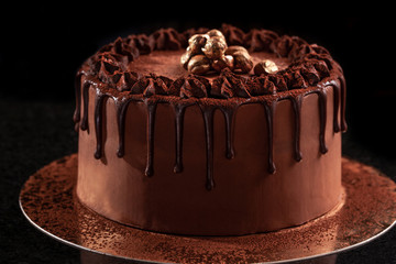 Chocolate cake with nuts on a black background