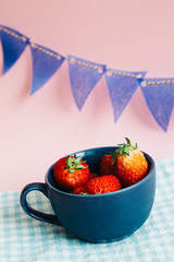 Strawberries in a cup with colorful party flag
