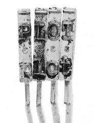 The word  PLOT with old typewriter hammers