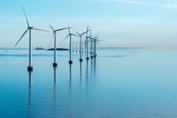 windmills in the sea with reflection