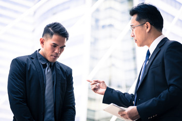 Two asian businessman has talking for business vision.
