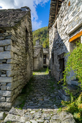 Fototapeta na wymiar path between two stone buildings old village