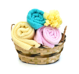 Obraz na płótnie Canvas towel. towel and carnation flower in basket on the background