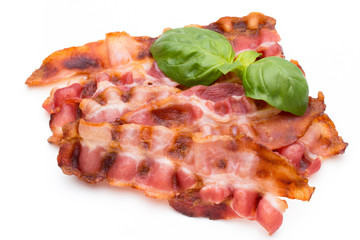 Cooked bacon rashers isolated on white.
