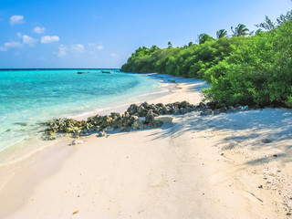 Maldives, Atoll, Indian Ocean. Spectacular bay with palm trees on the white sand beach. Turquoise water of the lagoon. Asdu in Male North.