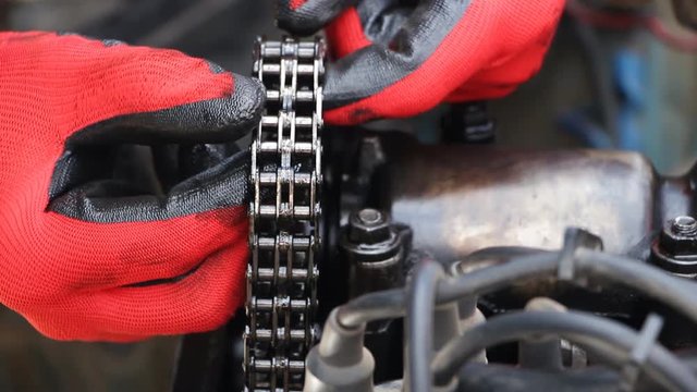car repair. A man checks the condition of the engine circuit