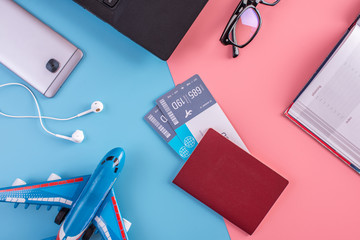 Plane, air tickets, passport, notebook and phone with glasses. The concept of planning for the travel