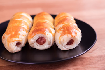 sausage in the dough on a white plate