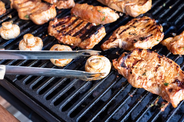 Grilled BBQ Burgers Patties On The Hot Flaming Charcoal Grill. Top View. Cookout Food, Good Snack For Outdoor Family Party Or Picnic.hamburgers cooking on grill with flames