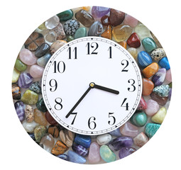 Crystal healer's Clock Border - Circular border of multicoloured tumbled healing stones with a white clock face showing 3.36 isolated on white
