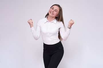 portrait of a beautiful brunette girl on a white background in a white shirt with different emotions in different poses