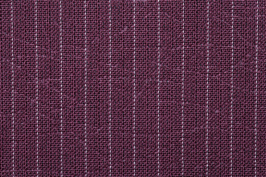 Closeup red color fabric sample texture backdrop. Red, maroon fabric strip line pattern design