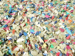Fototapeta na wymiar Shredded pieces of plastic in different colors