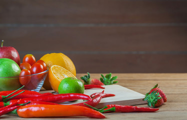 Healthy concept with mixed fruits and vegetables on wooden background