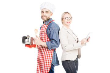 Portrait of cheerful male cook and confident businesswoman smiling at camera on white background