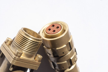 Brass four-pin electrical connector.