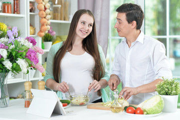 husband and wife cooking together