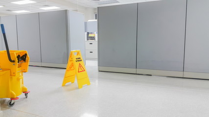 Sign showing warning of caution wet floor in the shopping store