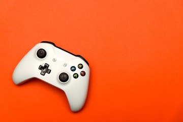 White joystick on orange textured background. Computer gaming competition videogame control...