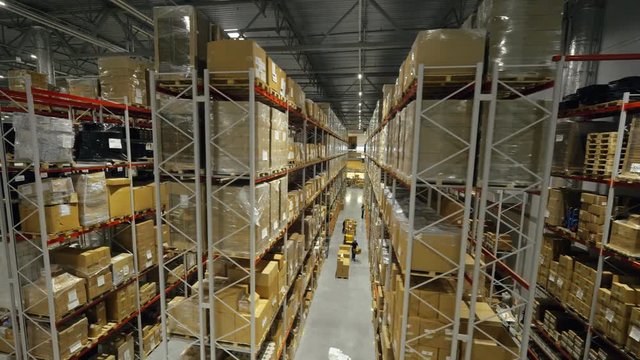 Boxes on high shelves at industrial warehouse on production plant drone view