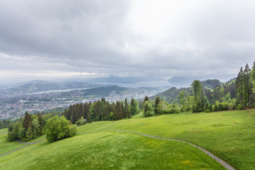Fototapeta premium View of the mountains, fields and forest in the Alps