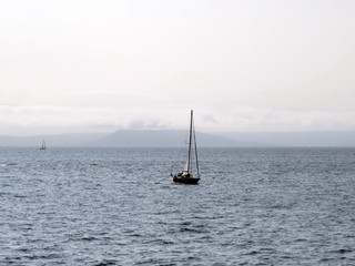 A yacht sailing under sail